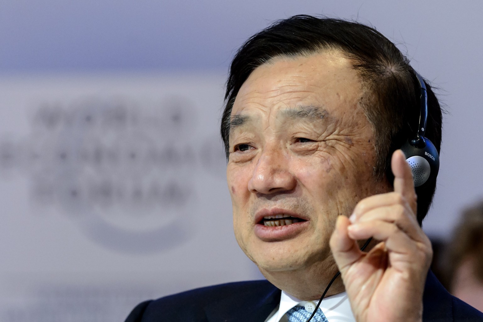 Huawei Founder and CEO Ren Zhengfei gestures as he attends a session of the World Economic Forum (WEF) annual meeting on January 22, 2015 in Davos. AFP PHOTO / FABRICE COFFRINI (Photo credit should read FABRICE COFFRINI/AFP/Getty Images)